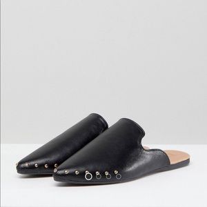 black mules rimmed with gold studs
